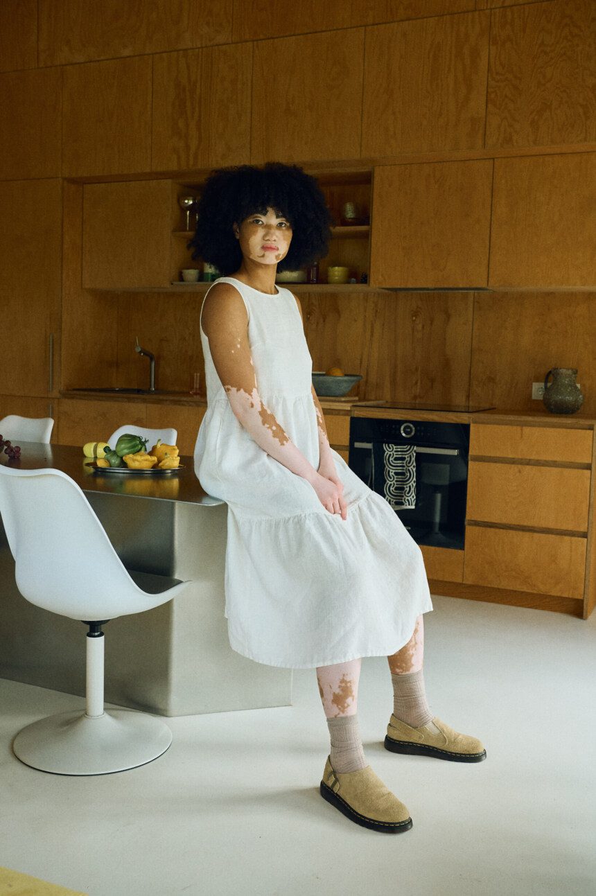 Flowing tiered silhouette of the milky white Amalie dress from a side angle