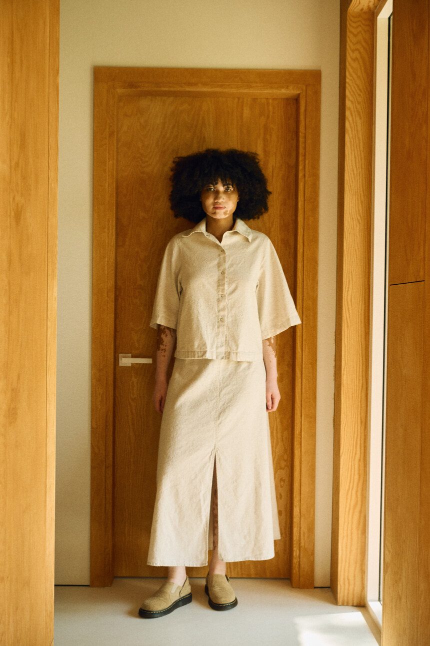 Natural linen-cotton set featuring a boxy shirt jacket worn over a high-waisted midi skirt