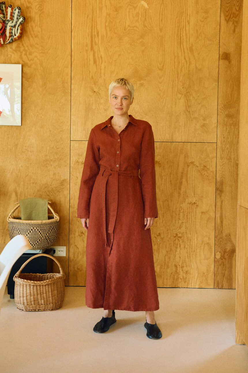 Heavy linen terracotta midi dress with collared bodice, long sleeves, and cinched belt